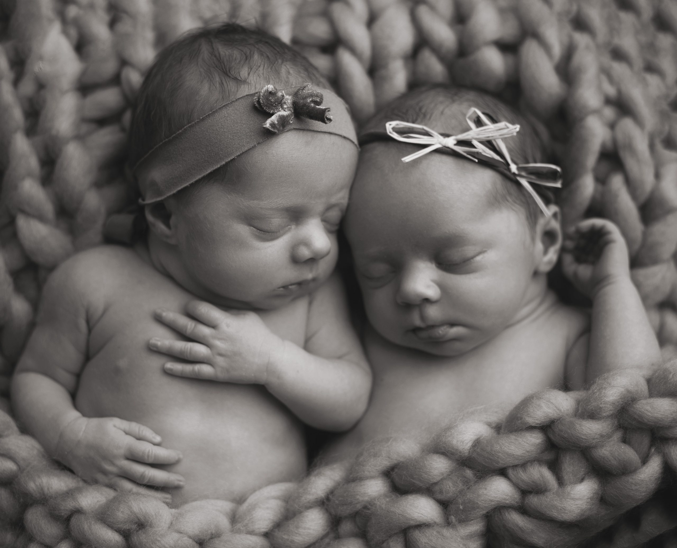 twin baby girls in a fluffy knitted blanket by Newborn Photographer In Great Finborough, Near Stowmarket, Ipswich & Bury St Edmunds