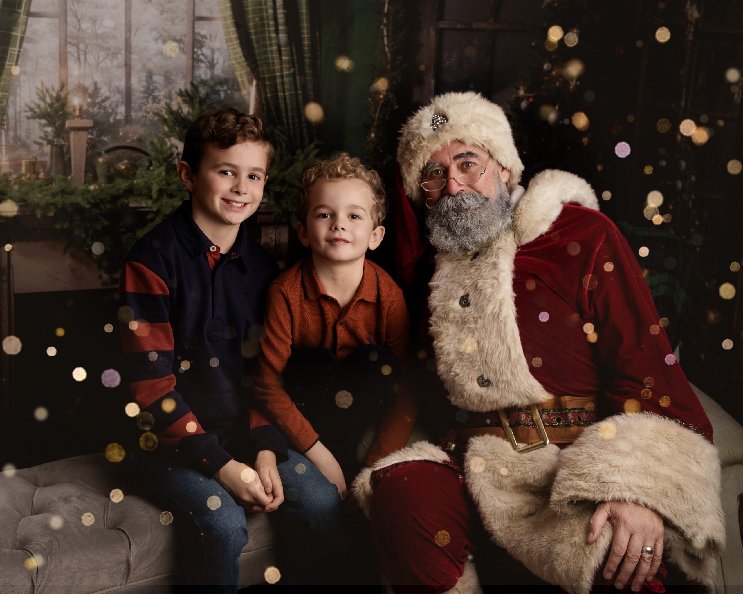 Santa Claus sitting with two happy little boys at Christmas in The Cow Shed Studio Stowmarket